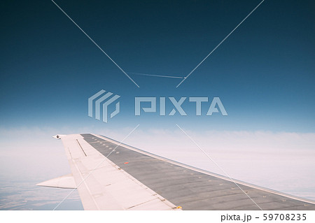 Contrail In Blue Sky. Plane In Sunny Sky. Aircraft In Sky With Plane Trail. View From Airplane 59708235