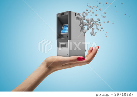 Side closeup of woman's hand facing up and holding small ATM which has started to dissolve into 59710237