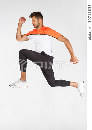 Vertical full-length shot sportsman in motion, attractive young football player, athlete jumping 59711853
