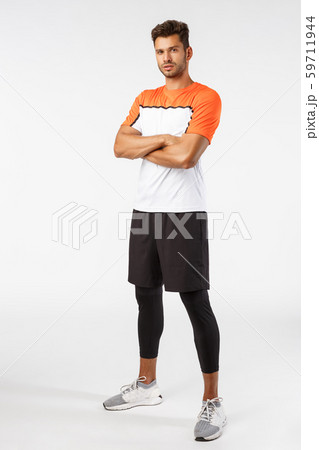 Confidence, sport and fitness concept. Vertical shot good-looking bearded handsome young sportsman Confidence, sport and fitness concept. Vertical shot good-looking bearded handsome young sportsman 59711944