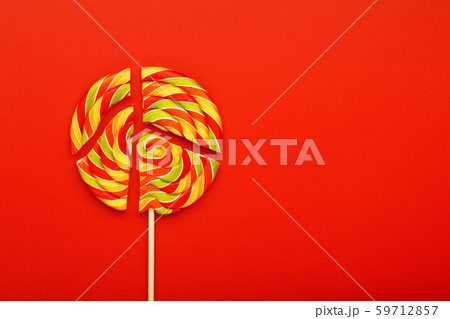 Lollipop broken into pieces on red background, top 59712857