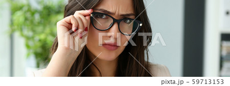 Young beautiful business woman holding glasses Young beautiful business woman holding glasses 59713153