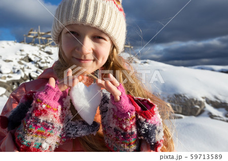 girl holds in her hands a heart of snow girl holds in her hands a heart of snow 59713589