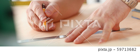 Arms of worker making structure plan on scaled paper closeup Arms of worker making structure plan on scaled paper closeup 59713682