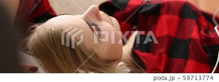 woman listen music lie on sofa 59713774