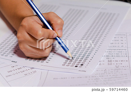 Students hand holding pencil writing selected Students hand holding pencil writing selected 59714460