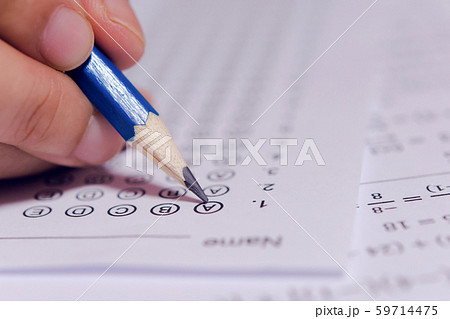 Students hand holding pencil writing selected Students hand holding pencil writing selected 59714475