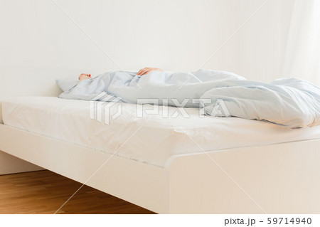 Man sleeping on a white bed 59714940