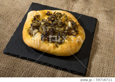 Homemade cebularz, Traditional Polish pancake with onion and common poppy seeds, from Jewish tradition, baked in Lublin, Poland. 59716711