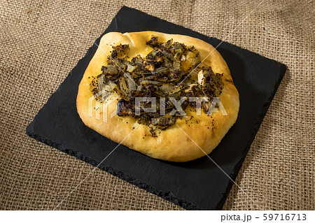 Homemade cebularz, Traditional Polish pancake with onion and common poppy seeds, from Jewish tradition, baked in Lublin, Poland. 59716713