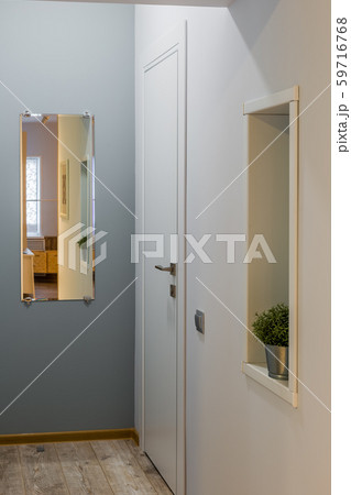 Beautiful hallway with a mirror in the house. Beautiful hallway with a mirror in the house. 59716768