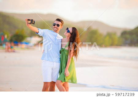 Young couple walking on tropical beach with white sand and turquoise ocean water at Antigua island 59717239