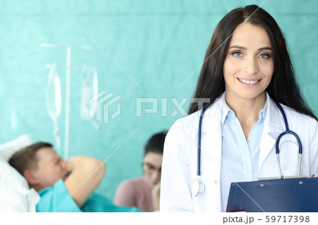 Pretty physician in medical gown Pretty physician in medical gown 59717398