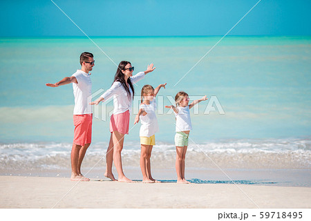 Happy beautiful family on the beach Happy beautiful family on the beach 59718495