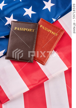 Two passports lying on American flag. Two passports lying on American flag. 59718509