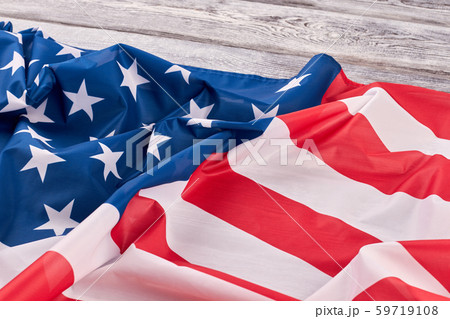 Crumpled flag of USA on wooden background. 59719108