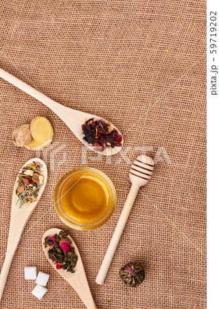 Tea leaves and honey on sackcloth, top view. 59719202