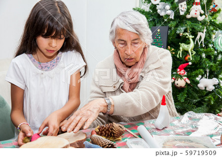 Grandmother teaching her granddaughter how to make christmas Nativity crafts Grandmother teaching her granddaughter how to make christmas Nativity crafts 59719509