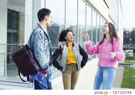cute group of teenages at the building of university with books huggings, diversity nations real cute group of teenages at the building of university with books huggings, diversity nations real 59720748