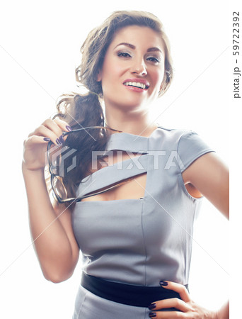 young pretty real brunette woman secretary in gray dress wearing glasses isolated on white young pretty real brunette woman secretary in gray dress wearing glasses isolated on white 59722392