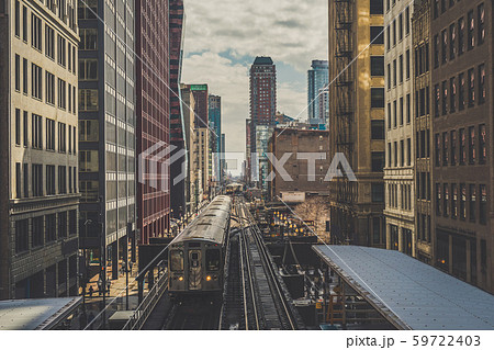 Elevated Train Tracks are running above the Railroad tracks between the building at the Loop line at Chicago, Illinois, USA Elevated Train Tracks are running above the Railroad tracks between the building at the Loop line at Chicago, Illinois, USA 59722403