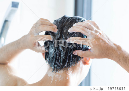 Closeup young man washing hair with with shampoo Closeup young man washing hair with with shampoo 59723055