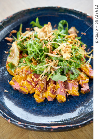 Roast beef, vegetables, carrot and oyster sauce. Sliced grilled beef barbecue Striploin steak and 59723612