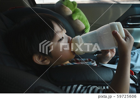 baby boy sucking milk on car seat safety drive 59725606