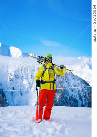 Portrait of sportive man in helmet with skis on his shoulder Portrait of sportive man in helmet with skis on his shoulder 59725964