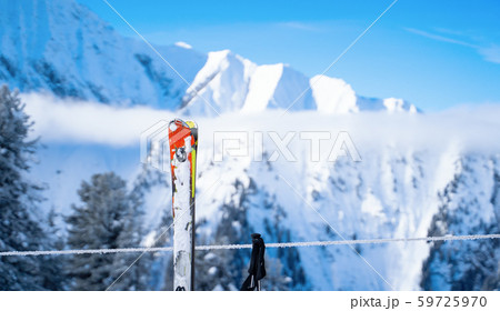 Skis, ski poles on background of mountains in snowy resort 59725970