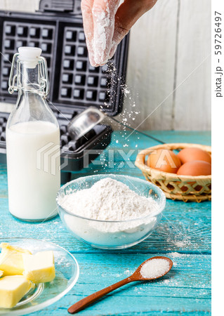 Making waffles at home. Pouring flour into a bowl 59726497