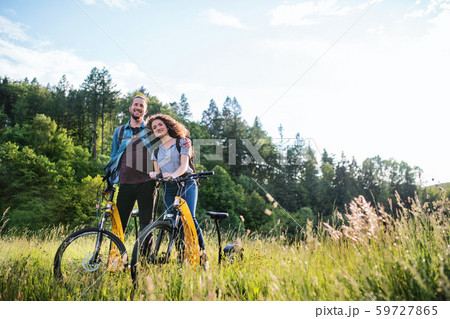 Young tourist couple travellers with electric scooters in nature. 59727865