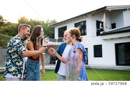 Portrait of people with wine outdoors on family garden barbecue. 59727908