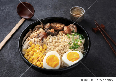 Ramen. Soba noodles with eggs, mushrooms, and vegetables, with sake, traditional wooden spoon, and Ramen. Soba noodles with eggs, mushrooms, and vegetables, with sake, traditional wooden spoon, and 59744405