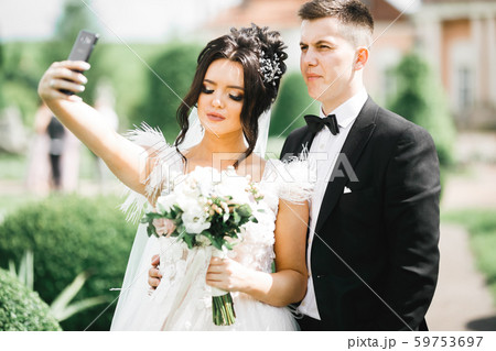 Young wedding couple taking a selfie of themselves 59753697