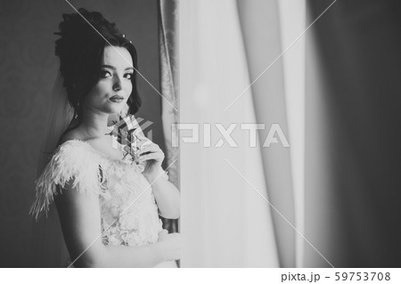 Beautiful bride wearing fashion wedding dress with feathers with luxury delight make-up and 59753708