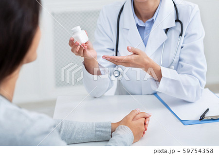 Doctor Giving Instructions On Treatment For Patient Sitting In Office Doctor Giving Instructions On Treatment For Patient Sitting In Office 59754358