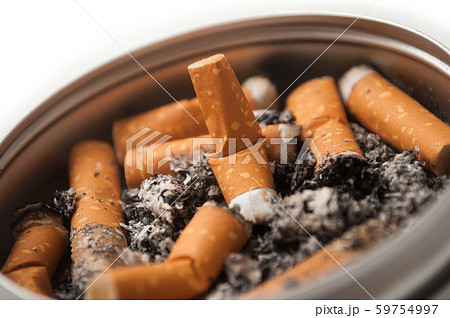 Closeup of metallic ashtray full of cigarettes Closeup of metallic ashtray full of cigarettes 59754997