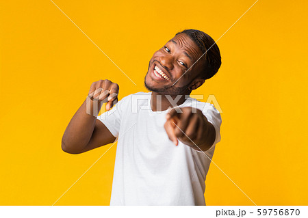 Smiling Black Guy Pointing Fingers At Camera Standing, Yellow Background 59756870