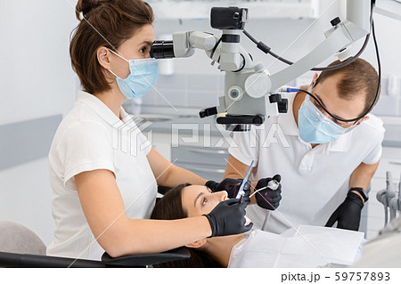 Skilled female dentist making surgery in dental office 59757893