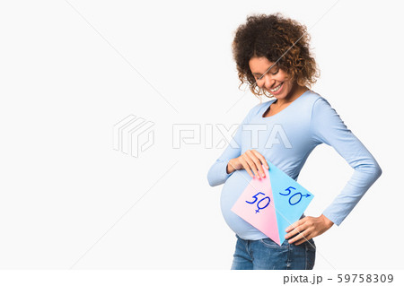 Expectant woman holding board with blue and pink colors 59758309