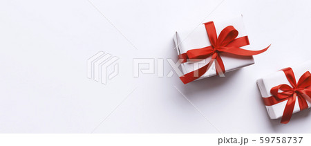 Christmas and New Year gifts wrapped in red ribbon on white Christmas and New Year gifts wrapped in red ribbon on white 59758737