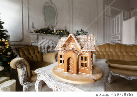 Postcard gingerbread house. Defocused lights of Christmas tree. Holiday mood. Christmas and Happy Postcard gingerbread house. Defocused lights of Christmas tree. Holiday mood. Christmas and Happy 59759868