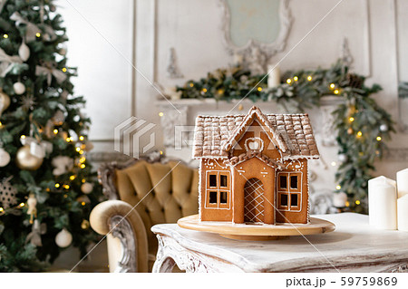 Postcard gingerbread house. Defocused lights of Christmas tree. Holiday mood. Christmas and Happy Postcard gingerbread house. Defocused lights of Christmas tree. Holiday mood. Christmas and Happy 59759869