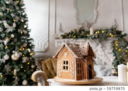 Postcard gingerbread house. Defocused lights of Christmas tree. Holiday mood. Christmas and Happy Postcard gingerbread house. Defocused lights of Christmas tree. Holiday mood. Christmas and Happy 59759870