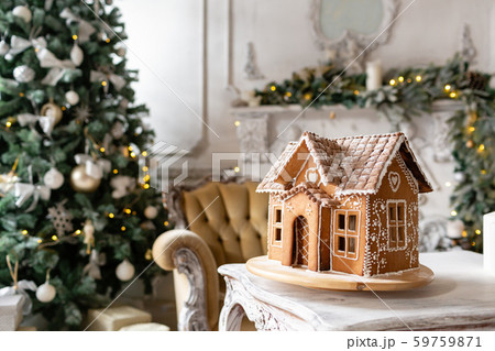 Postcard gingerbread house. Defocused lights of Christmas tree. Holiday mood. Christmas and Happy Postcard gingerbread house. Defocused lights of Christmas tree. Holiday mood. Christmas and Happy 59759871