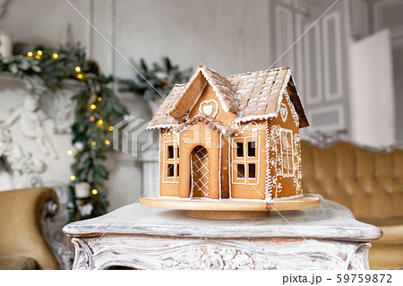 Postcard gingerbread house. Defocused lights of Christmas tree. Holiday mood. Christmas and Happy 59759872