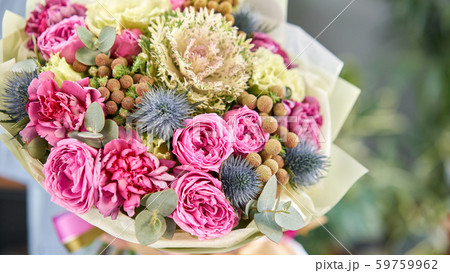 European floral shop. Beautiful bouquet of mixed flowers in womans hands. the work of the florist at European floral shop. Beautiful bouquet of mixed flowers in womans hands. the work of the florist at 59759962