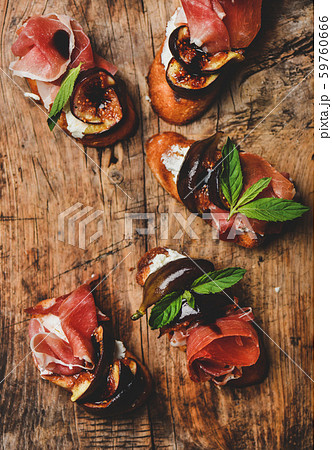 Crostini with prosciutto, cheese and figs on Crostini with prosciutto, cheese and figs on 59760666