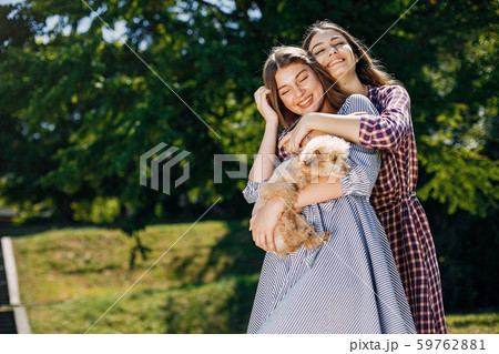 Elegant and stylish girls in a spring park Elegant and stylish girls in a spring park 59762881